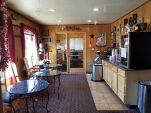 a restaurant with two tables and chairs and a kitchen at Gold Pan Lodge in Quincy