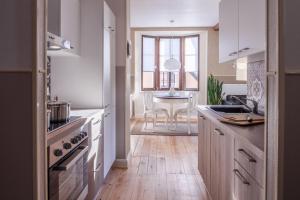 a kitchen with white cabinets and a table in it at Charming FRIEDA in Maybach