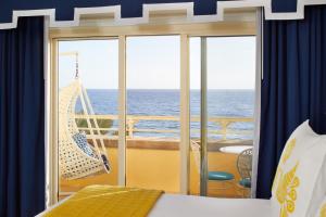 a bedroom with a hammock on a cruise ship at Eau Palm Beach Resort & Spa in Palm Beach
