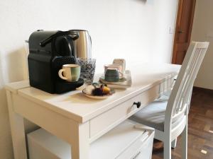 a table with a coffee maker on top of it at Sleep & Fly in Bologna