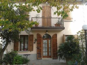 a building with wooden doors and a balcony at Sleep & Fly in Bologna