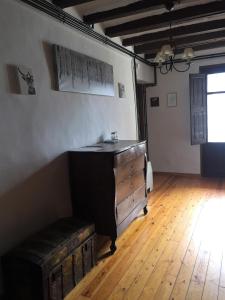 an attic room with a dresser and a wooden floor at Casa Coll in Barruera