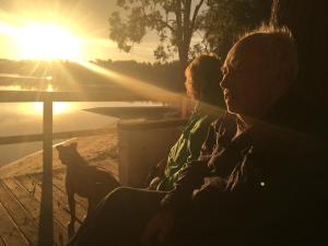 two people sitting on a bench watching the sunset at Discovery Parks - Forster in Tuncurry