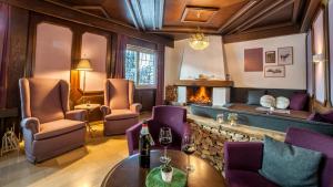 ゼーフェルト・イン・チロルにあるBoutique Hotel Olympiaの暖炉、テーブル、椅子が備わるレストラン