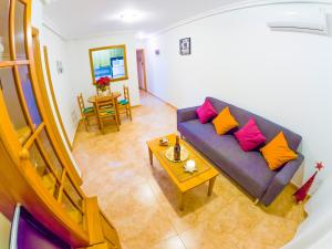トレビエハにあるHomely apartments Radio Murciaの紫色のソファとテーブル付きのリビングルーム