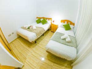 Postel nebo postele na pokoji v ubytování Homely Apartments Blasco Ibañez