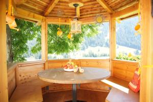 a table in a room with a large window at Appartamenti Loretta in La Villa