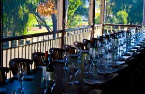 a long table with wine glasses on a balcony at The Bridgetown Hotel in Bridgetown