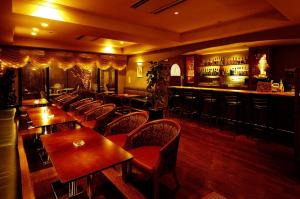 a restaurant with tables and chairs and a bar at Hotel Riverge Akebono in Fukui