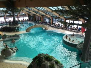 a pool in a building with people swimming in it at Apartma NEVA in Bohinj