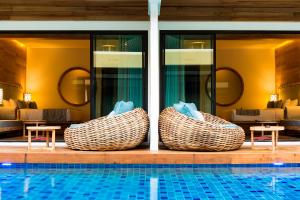 a resort with a swimming pool with two wicker baskets at AKIRA Lipe Resort in Ko Lipe