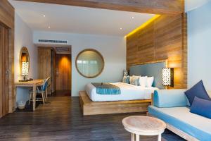 a bedroom with a bed and a couch at AKIRA Lipe Resort in Ko Lipe