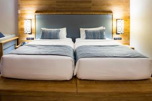 two beds sitting next to each other in a bedroom at AKIRA Lipe Resort in Ko Lipe
