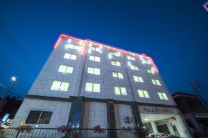 a tall building with lights on top of it at Big O Show Guesthouse in Yeosu