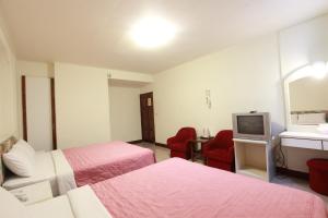 Postel nebo postele na pokoji v ubytování Yong Qi Hotel