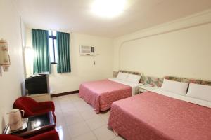 Postel nebo postele na pokoji v ubytování Yong Qi Hotel