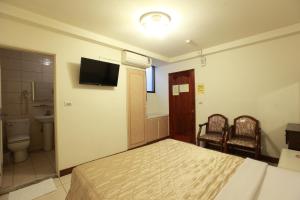 Postel nebo postele na pokoji v ubytování Yong Qi Hotel