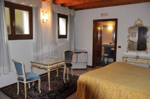 sypialnia z łóżkiem, stołem i krzesłami w obiekcie Hotel Sogno w mieście Rezzato