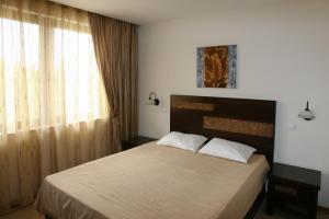 A bed or beds in a room at Private Villa 102 with heated pool in BlackSeaRama