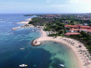 an aerial view of a beach with boats in the water at Tanjung Sari Inn in Nusa Dua