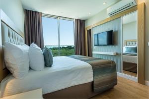 A bed or beds in a room at Aska Lara Resort & Spa Hotel