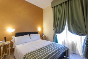 ein Schlafzimmer mit einem Bett und einem großen Fenster in der Unterkunft Hotel Regina Giovanna in Rom