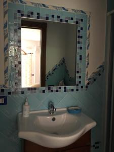 a bathroom with a sink and a mirror at Luna D'Agerola in Agerola
