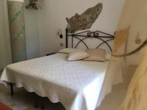 a bedroom with a bed with a white comforter at Luna D'Agerola in Agerola