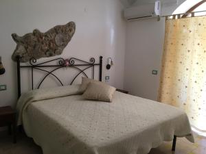 a bedroom with a bed with a white comforter at Luna D'Agerola in Agerola