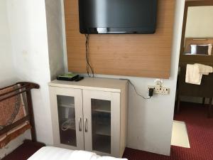 a small cabinet with a television on top of it at Mae KB Guesthouse at Khalifa Hotel in Kota Bharu