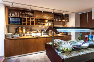 a kitchen with a counter and a table with dishes at Poseidon Hotel in Meyisti