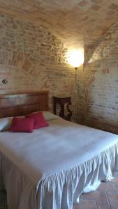 a bedroom with a large bed in a brick wall at Villa Perenich in Chieti
