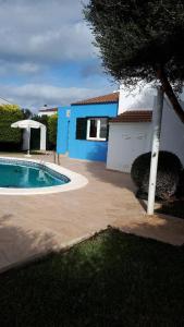 a house with a swimming pool in front of a house at Villa Desi in Cala en Blanes