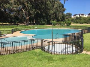 a swimming pool with a fence around it at Departamento Maitencillo Costamai in Maitencillo