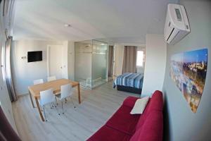 a living room with a red couch and a table at Luxury and cozy apartment MALAGA in Málaga