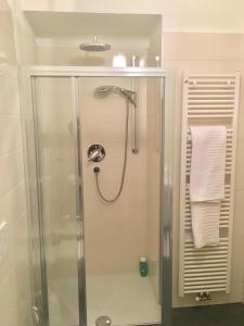 a shower with a glass door in a bathroom at Appartamento Nadia in Merano