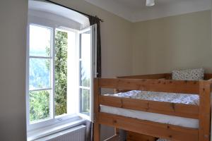 a bunk bed in a room with a window at Altes Pfarrhaus Altersberg in Trebesing