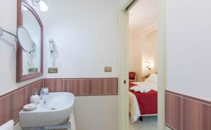 a bathroom with a sink and a mirror and a bed at B&B Palazzo Montesanto in Maiori +37 photos