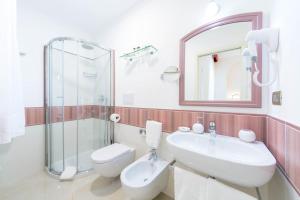 a bathroom with a sink and a toilet and a mirror at B&B Palazzo Montesanto in Maiori