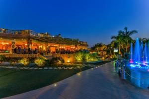 a fountain in front of a building at night at Al Masa Hotel Nasr City in Cairo