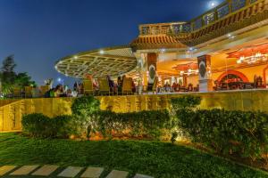 a large building with a lawn in front of it at Al Masa Hotel Nasr City in Cairo