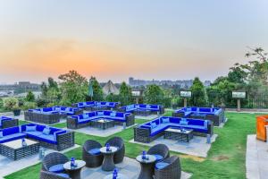a group of blue chairs and tables on a lawn at Al Masa Hotel Nasr City in Cairo