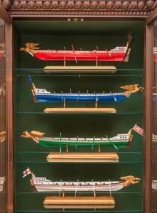 a display of wooden boats in a wooden case at B&B Palazzo Montesanto in Maiori