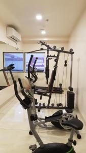 a gym with two tread machines in a room at The AVR Hotels & Banquets in Patna