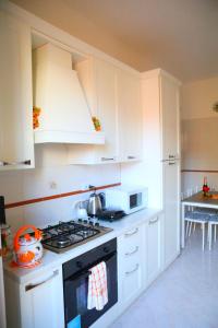 a kitchen with white cabinets and a stove top oven at Linda Musei Vaticani in Rome +22 photos