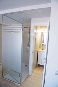 W łazience znajduje się szklana kabina prysznicowa i umywalka. w obiekcie Modern & Stylish Loft with Breathtaking Views FREE WIFI - Close to the sea w Maladze