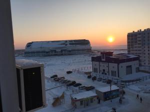 a view of a city in the snow at sunset at Apartment Erofey Arena at Sysoeva 8 in Khabarovsk