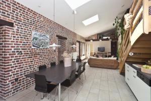 a kitchen and dining room with a brick wall at Fleur de Ciel in Loos-en-Gohelle