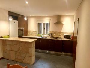 a kitchen with a sink and a counter in it at A nossa Casa Gerês in Geres