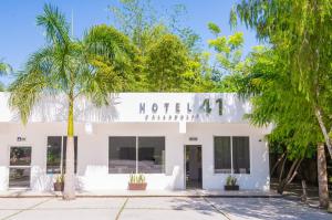 a hotel with palm trees in front of a building at Hotel 41 Valladolid in Valladolid